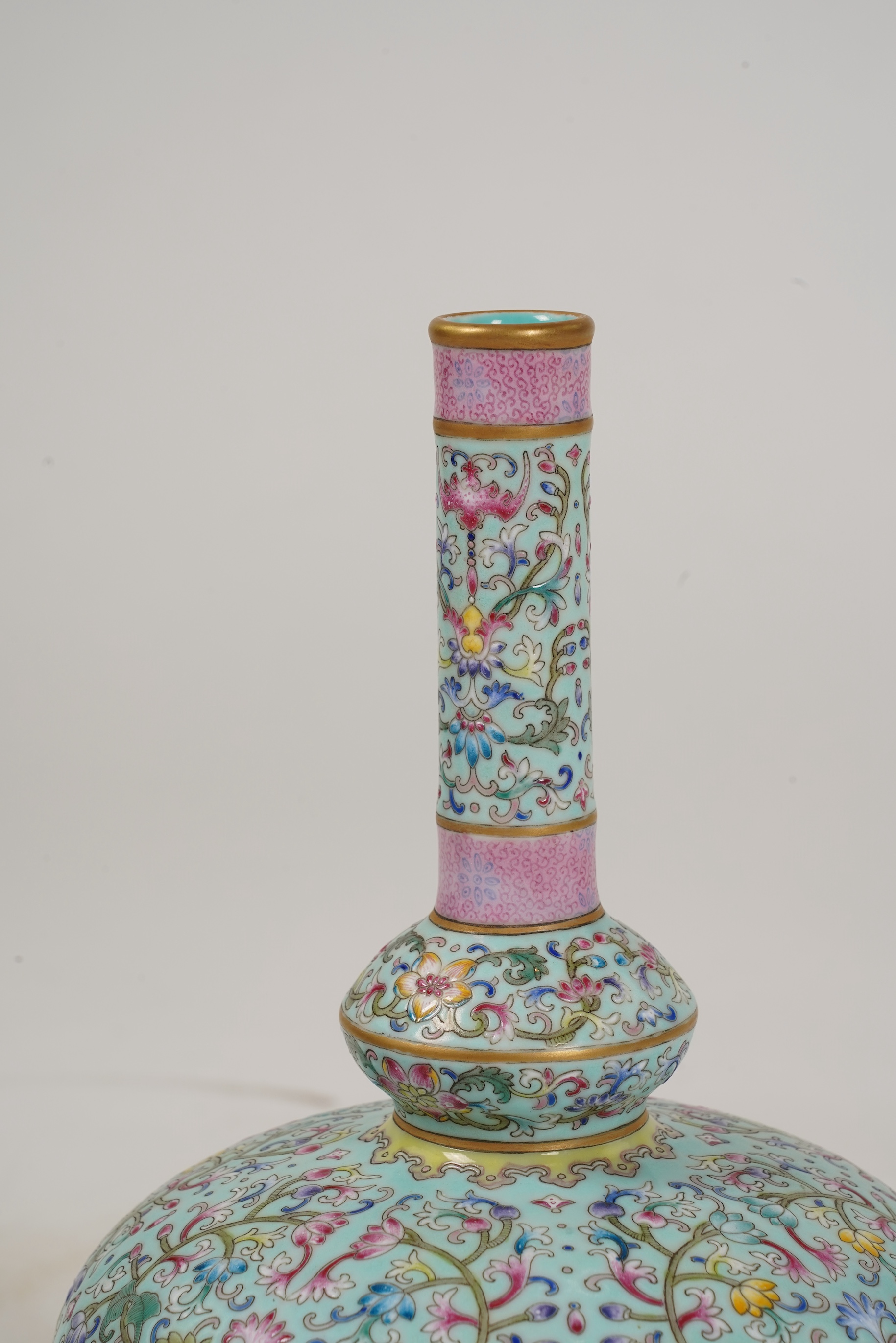 A pair of Chinese famille rose enamelled porcelain bottle vases, Qianlong seal mark to base but Republic Period
